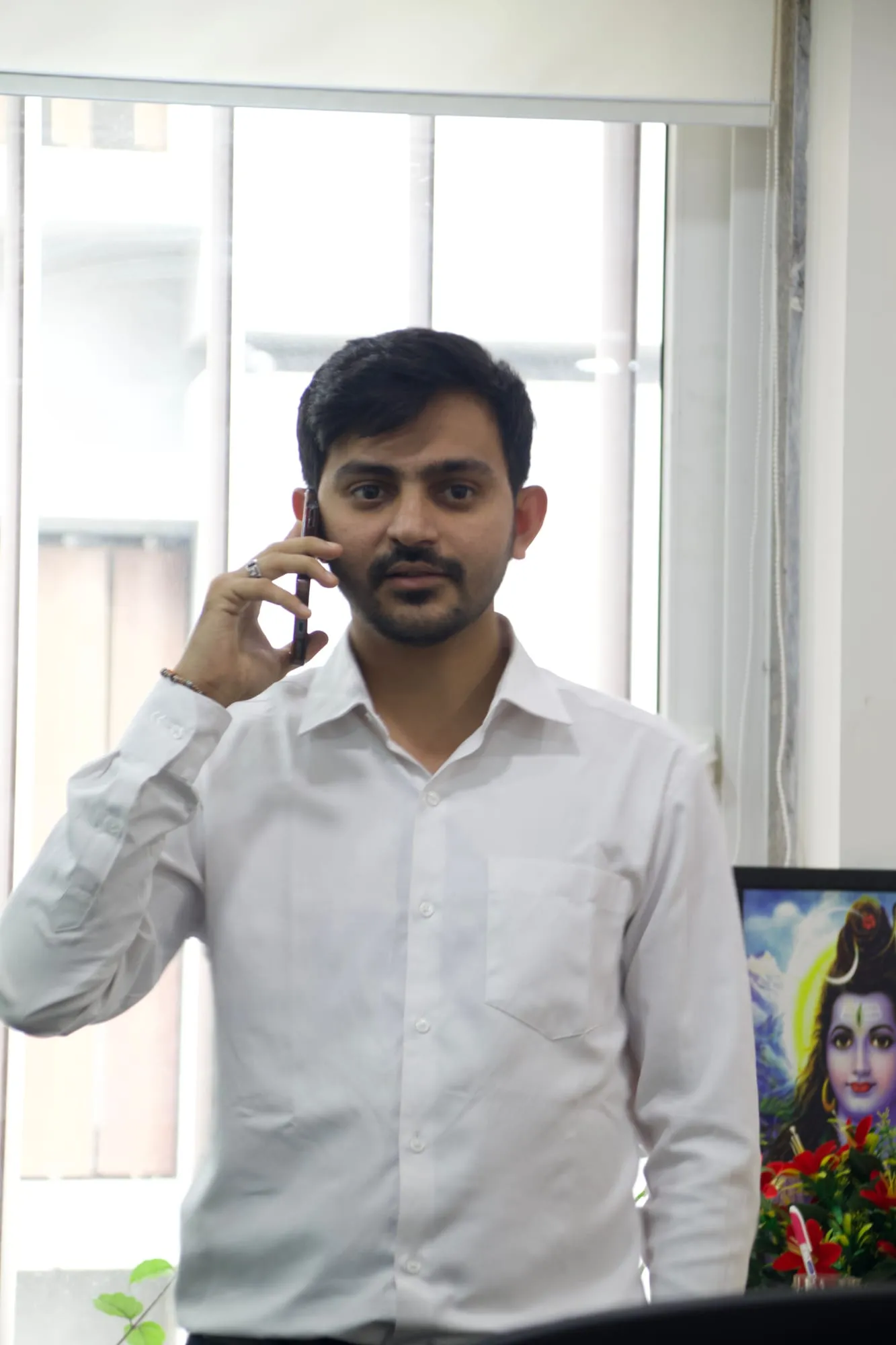 Mukesh Chaudhary on a call Mukesh Chaudhary on a phone call at his office